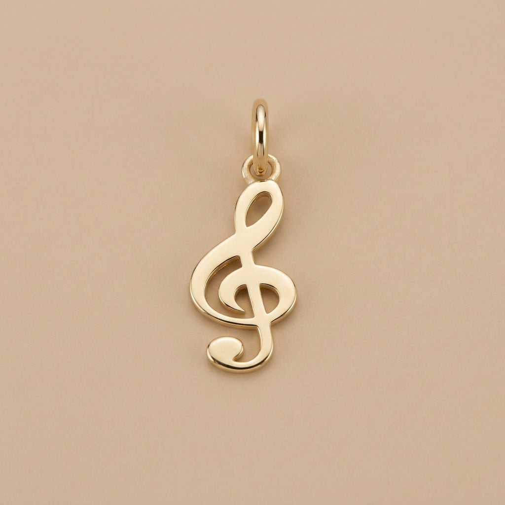 A screenshot of an e-commerce product grid showing various gold jewelry pendants, including a treble clef pendant, a paw print pendant, and a gold pendant with a green gemstone, with product codes, quantities, and prices listed next to each item.